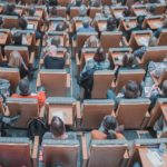 high-angle photography of group of people sitting at chairs